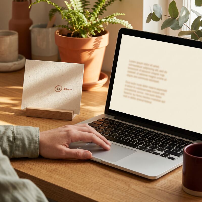 Business owner scheduling a quarterly agents.txt review, laptop and desk calendar in warm natural light, AI SEO upkeep