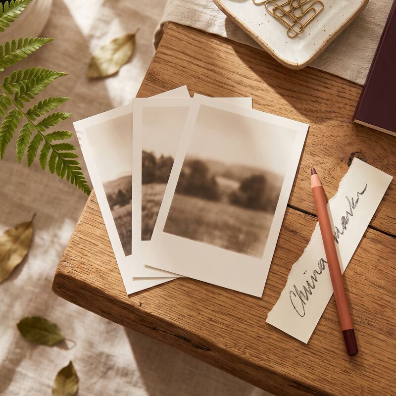 Printed AI-generated image proofs compared side by side with markup pen on timber desk, choosing an image generator Printed AI-generated image proofs compared side by side with markup pen on timber desk, choosing an image generator