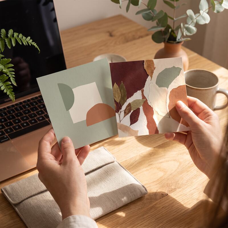 Hands comparing a DIY template graphic with a custom professional design print in warm terracotta and sage tones Hands comparing a DIY template graphic with a custom professional design print in warm terracotta and sage tones