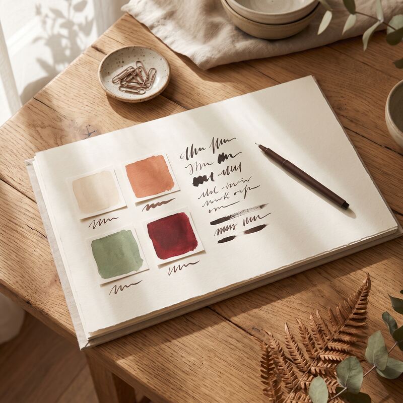 Custom brand style guide with terracotta and sage colour swatches on a timber desk, professional design system detail Custom brand style guide with terracotta and sage colour swatches on a timber desk, professional design system detail