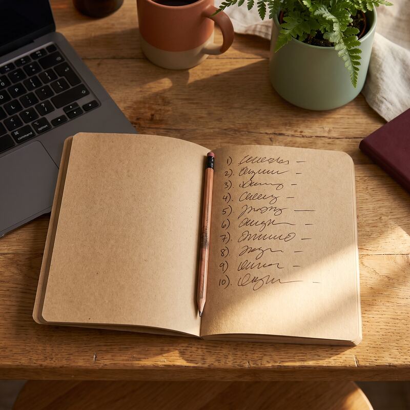 Notebook with a handwritten plan for structuring a Claude skill file beside a laptop keyboard in warm light Notebook with a handwritten plan for structuring a Claude skill file beside a laptop keyboard in warm light