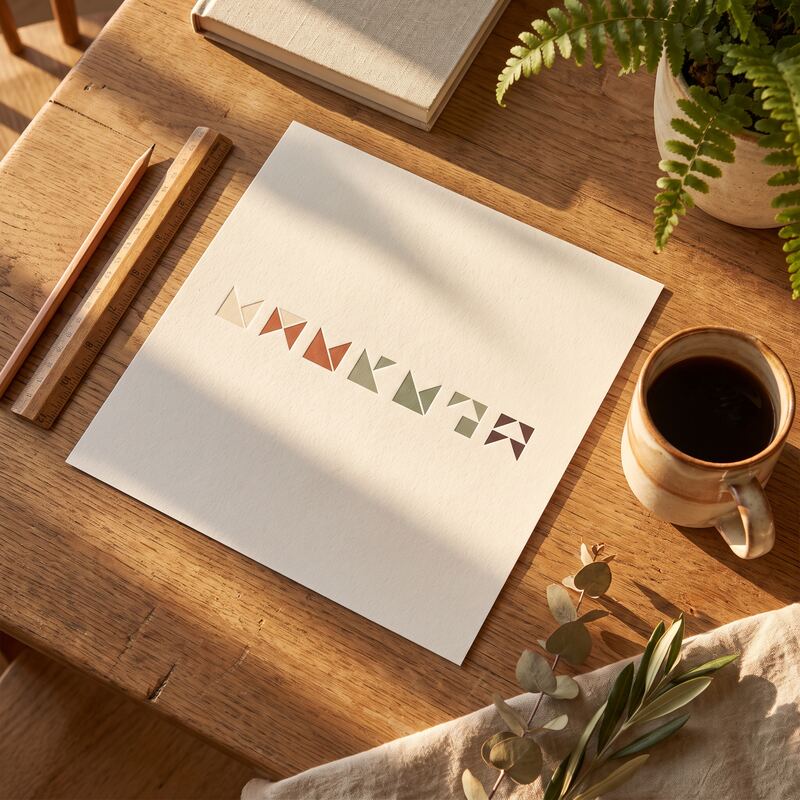 Printed sheet of matching isometric graphic thumbnails checked for brand consistency with ruler and pencil on warm timber Printed sheet of matching isometric graphic thumbnails checked for brand consistency with ruler and pencil on warm timber