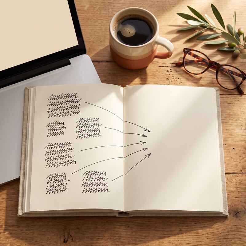 Overhead desk with notebook of scribbled parallel task arrows, laptop and coffee — planning simultaneous AI agent workflows Overhead desk with notebook of scribbled parallel task arrows, laptop and coffee — planning simultaneous AI agent workflows